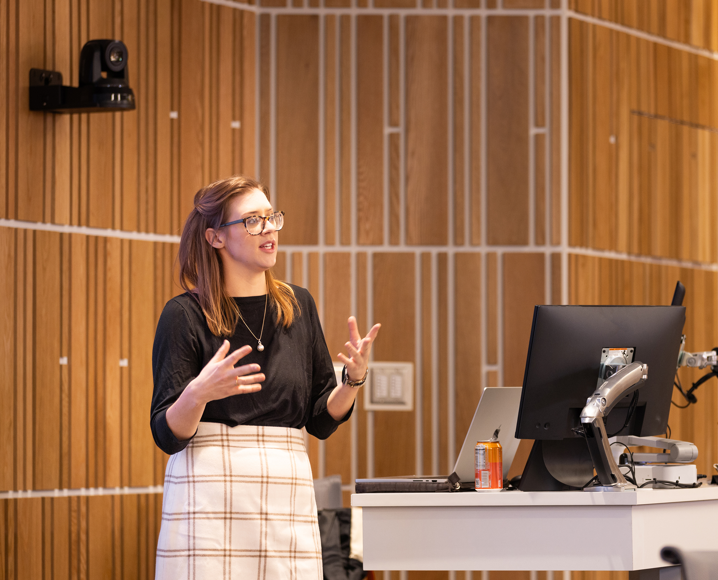 A Syracuse University professor stands at the front of a lecture hall